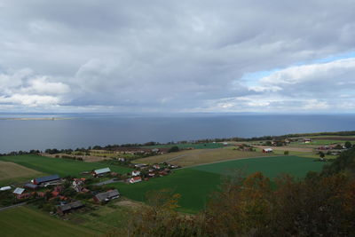 High angle view of land and sea against sky