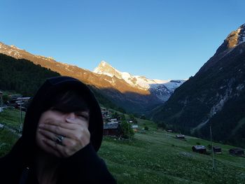 Beautiful woman in mountains against clear sky