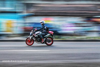 Side view of a person riding bicycle on road in city