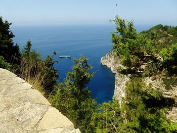 High angle view of rocks by sea against sky