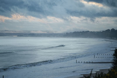 A view looking south from bournemouth pier of the southwest coastline of dorset.