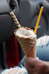 Close-up of hand holding ice cream