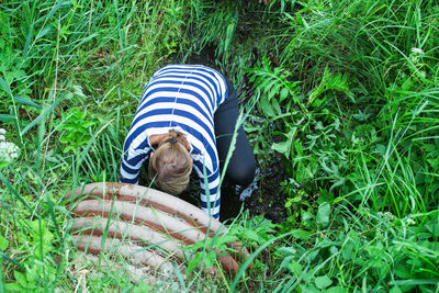 Low section of person relaxing on field