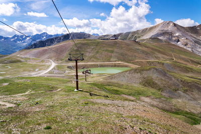 Ski lift on mountain against sky