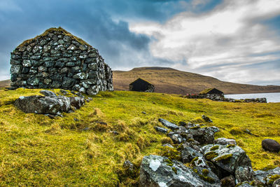 An old abandoned hamlet in the faroe islands. mountains and lake on background. high quality photo