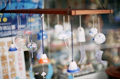 Close-up of decorations hanging in store for sale