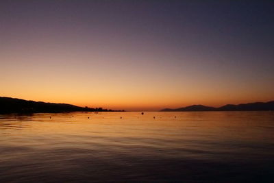 Scenic view of sea and mountains during sunset