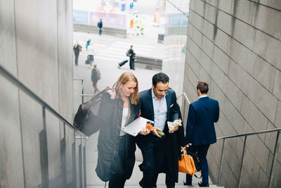 High angle view of mature business colleagues on staircase in city