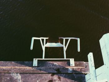 High angle view of ladder by pier at sea
