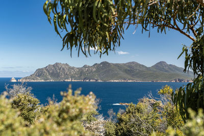 Scenic view of sea and mountains against sky