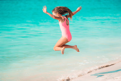Young woman jumping in sea