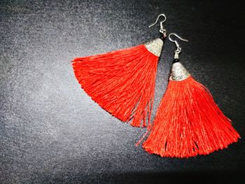 Close-up of red umbrella hanging over black background