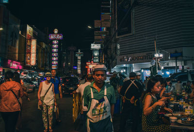 People on city street at night