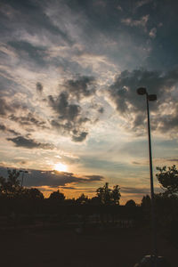 Low angle view of silhouette street against sky during sunset