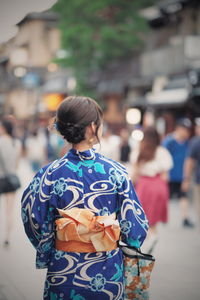 Rear view of woman walking outdoors