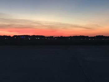 Silhouette landscape against sky at sunset