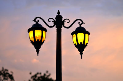 Low angle view of silhouette street light against sky during sunset