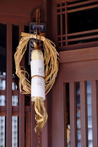 Low angle view of decoration hanging on rope against building