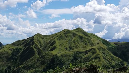 Panoramic view of green landscape against sky