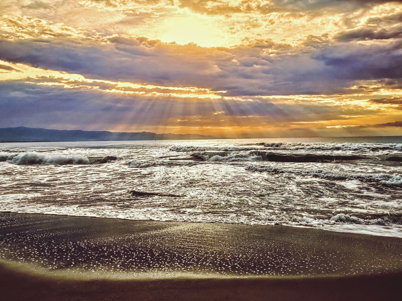 sky, sea, water, sunset, beauty in nature, cloud, land, scenics - nature, ocean, beach, nature, sunlight, shore, wave, horizon, tranquility, reflection, sand, coast, tranquil scene, no people, environment, dawn, wind wave, sun, dramatic sky, idyllic, outdoors, motion, water sports, landscape, sports, body of water, evening, travel, travel destinations, horizon over water, sunbeam
