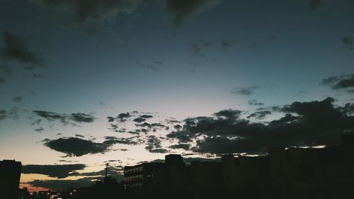 Silhouette cityscape against sky during sunset