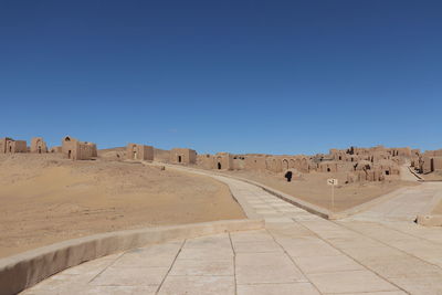 View of ruins against clear blue sky