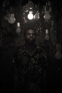 Portrait of man in illuminated light bulb