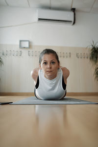 Woman practicing pilates exercises in class