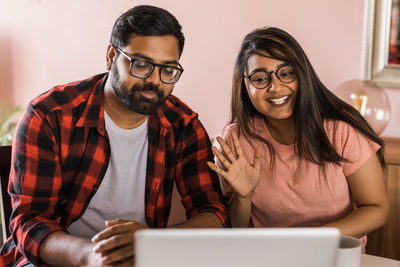 Young woman using laptop at home