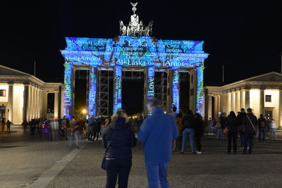 Group of people in front of building at night