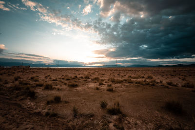 Scenic view of desert against sky during sunset