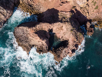 High angle view of rocks in sea