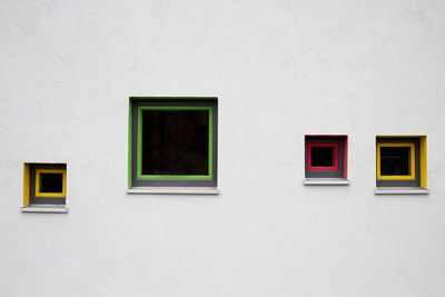 Colored window frames on white wall