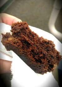 Close-up of hand holding cake slice in plate