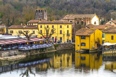 High angle view of borghetto sul mincio with the buildings reflecting on the water