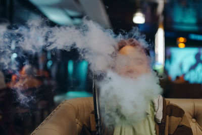 Portrait of man smoking outdoors