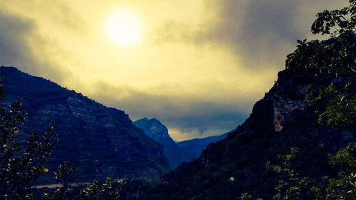 Scenic view of mountains against sky at sunset