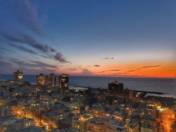 High angle view of illuminated buildings against sky during sunset
