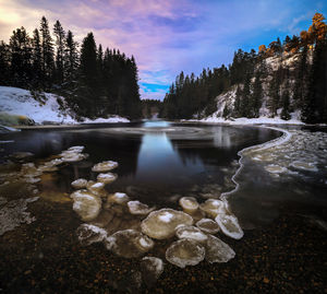 Scenic view of lake against sky during winter