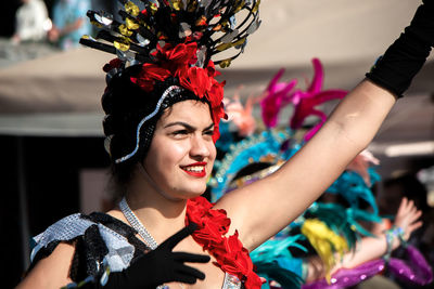 Portrait of happy woman with arms raised