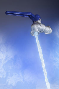 Low angle view of icicles against blue sky