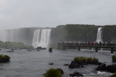 Scenic view of waterfall against sky