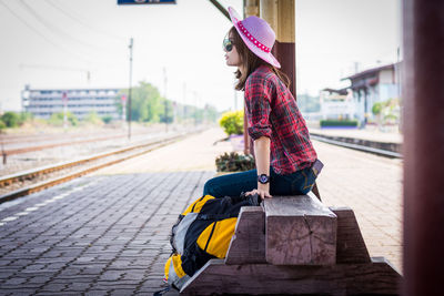 Woman looking at railroad station platform