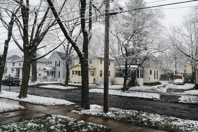 Snow covered road in city