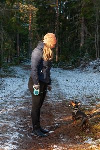Full length of a dog on snow covered land