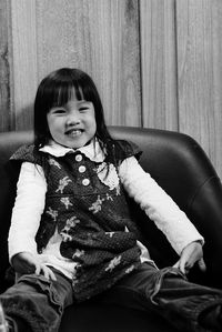Portrait of cute girl sitting at home