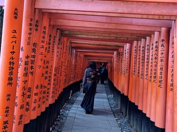 Rear view of woman on temple outside building