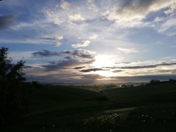 Scenic view of field against sky during sunset