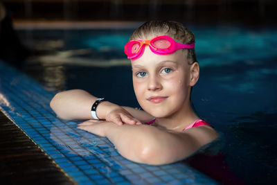 Portrait of teenage girl swimming in pool