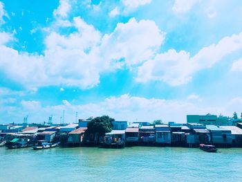 Boats moored on sea against buildings